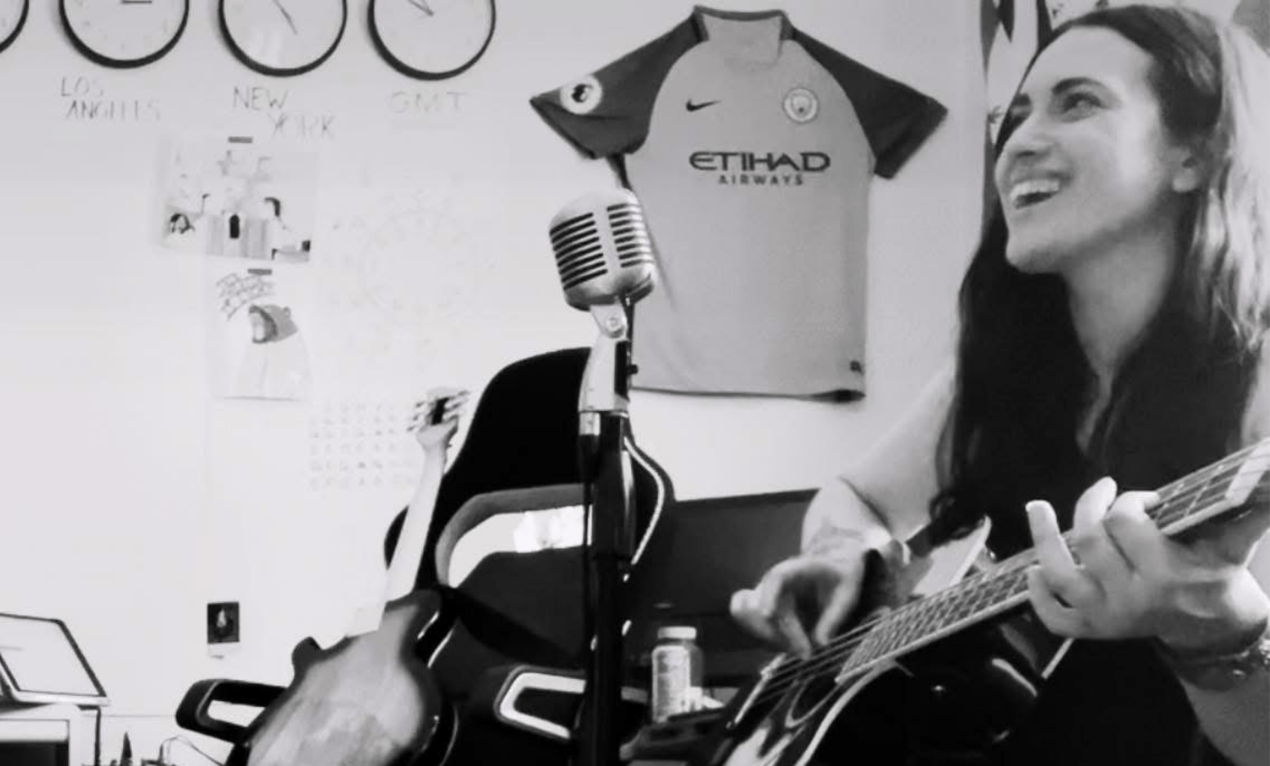 bpd and jesus, bpd christians: sarah playing an acoustic bass with a wide smile